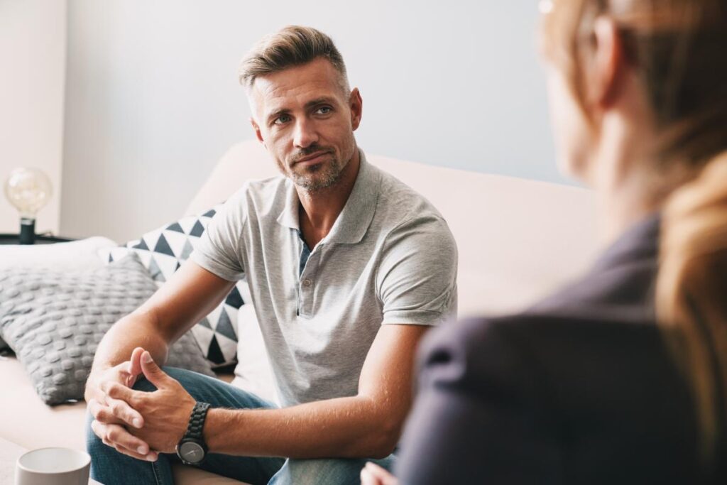 A man listens during addiction therapy