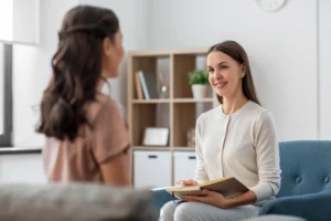A woman talks to a provider about insurance coverage for addiction treatment.
